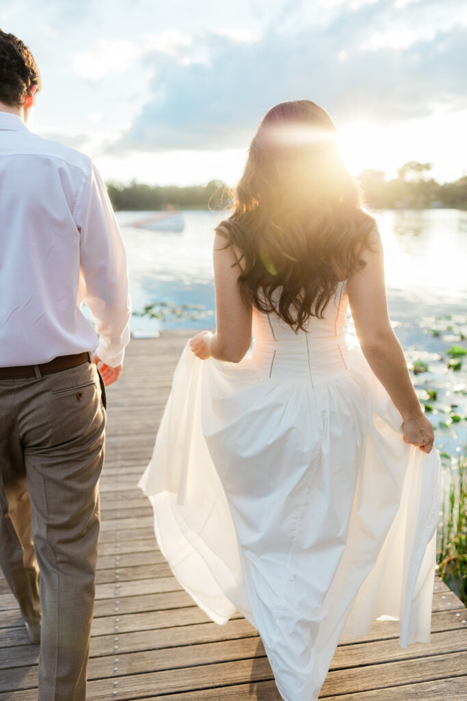 Engagement photos lakeside at  Rollins College with the sunset coming down captured by Orlando wedding photographer, Angelika Krug Photo & Film. 