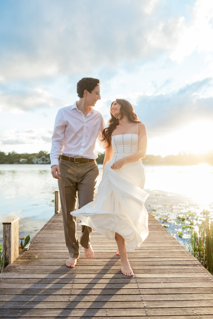 Engagement photos lakeside at  Rollins College with the sunset coming down captured by Florida wedding photographer, Angelika Krug Photo & Film. 