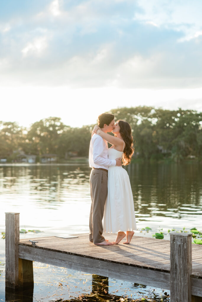 Engagement photos lakeside at  Rollins College with the sunset coming down captured by Orlando wedding photographer, Angelika Krug Photo & Film. 