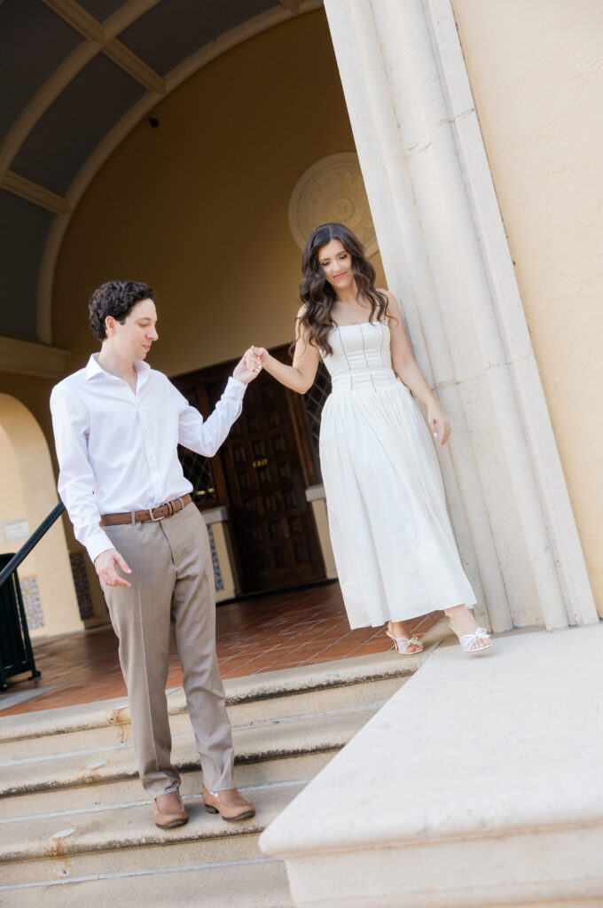 Engagement photos in font of the library at Rollins College captured by Orlando wedding photographer, Angelika Krug Photo & Film. 