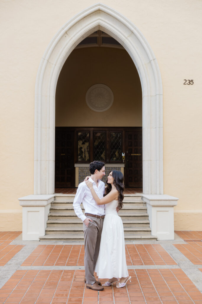 Engagement photos in font of the library at Rollins College captured by Orlando wedding photographer, Angelika Krug Photo & Film. 