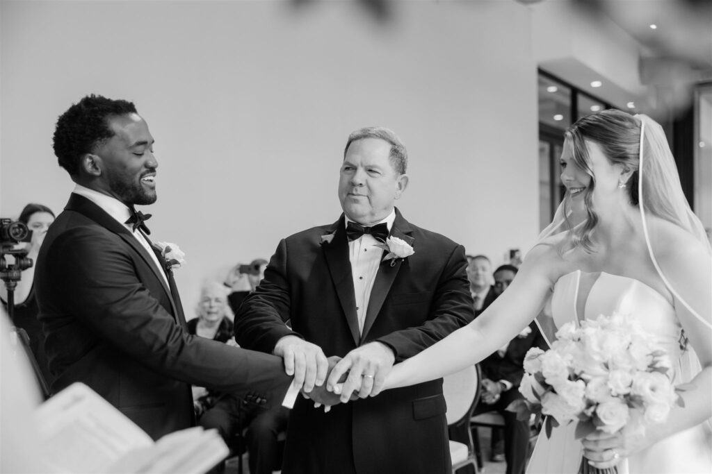 Black and white image of the father of the bride giving away his daughter at a wedding at the Ben Palm Beach captured by Palm beach wedding photographer. 